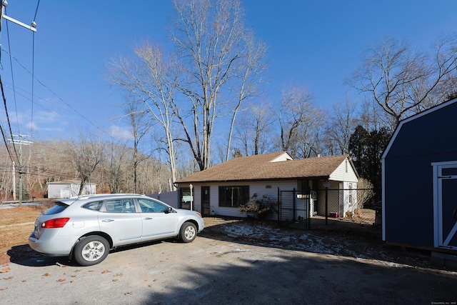 view of front of home featuring a storage shed