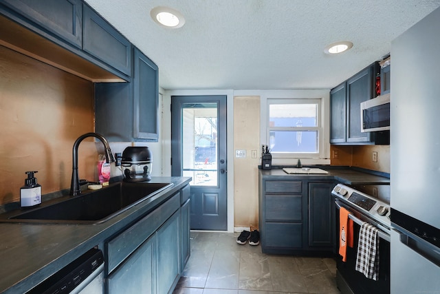 kitchen with white dishwasher, electric range oven, sink, and a textured ceiling