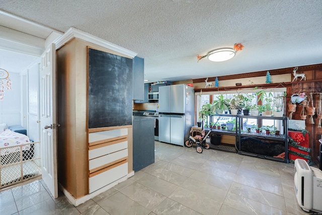 kitchen with a textured ceiling and stainless steel appliances