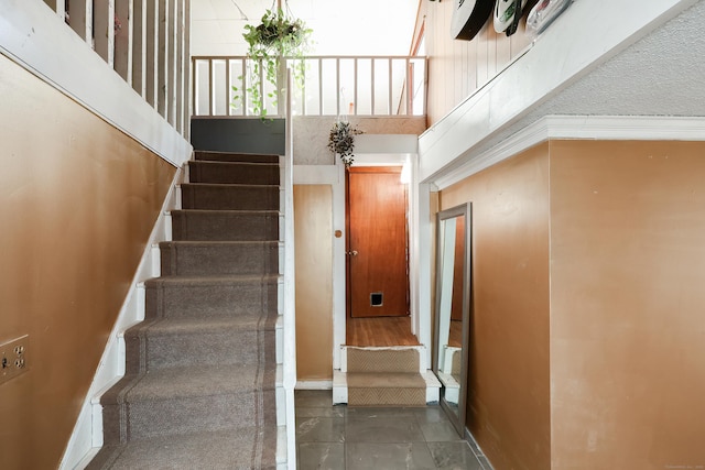 stairs featuring a high ceiling