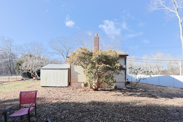 rear view of house with a storage unit