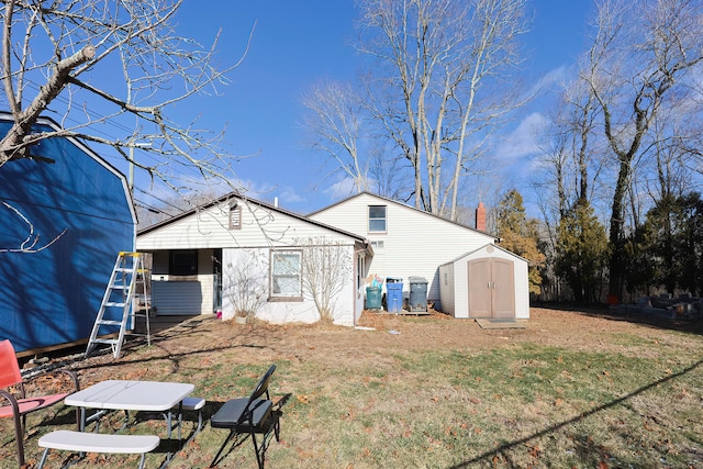 back of house with a shed and a yard