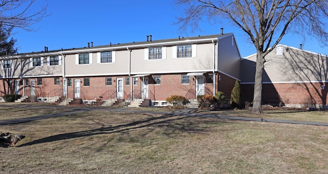 rear view of property featuring a yard