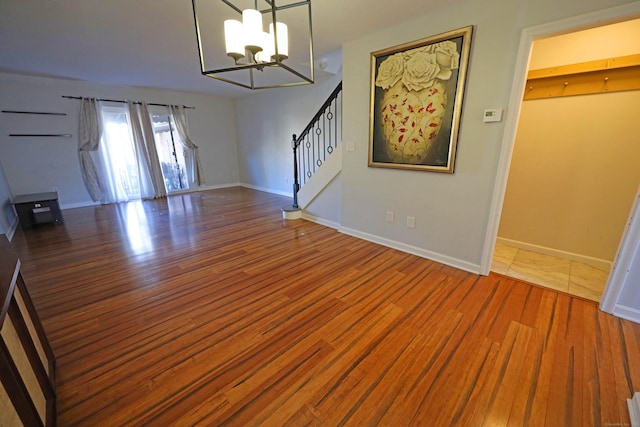 interior space featuring wood-type flooring and a chandelier