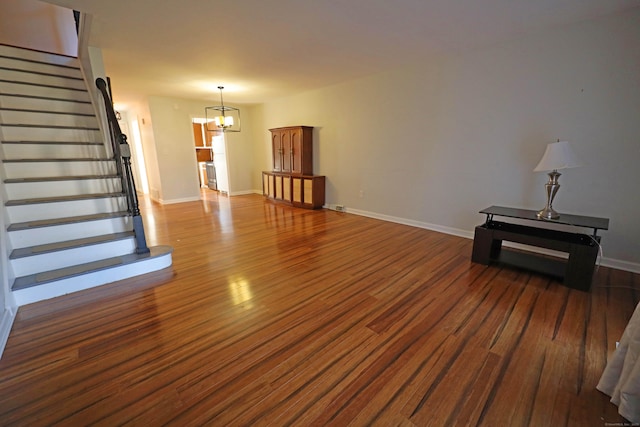 living room featuring a chandelier and dark hardwood / wood-style floors