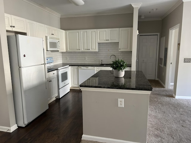 kitchen featuring white cabinets, a center island, white appliances, and dark stone counters