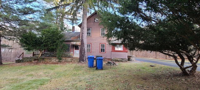 view of side of home with a yard