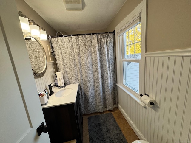 bathroom with curtained shower and vanity