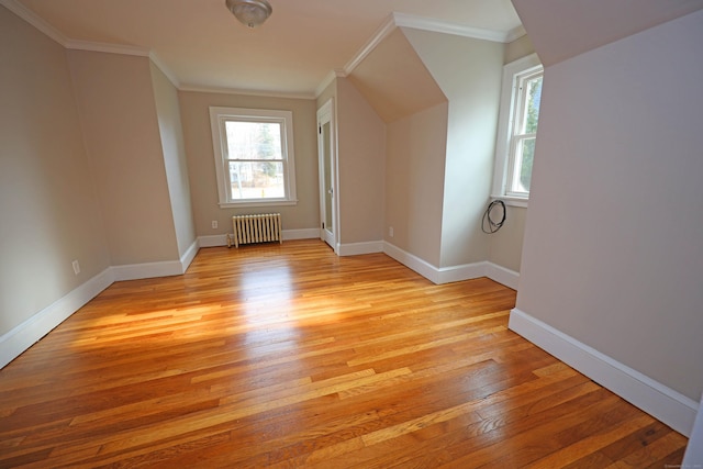 bonus room with radiator and light hardwood / wood-style flooring