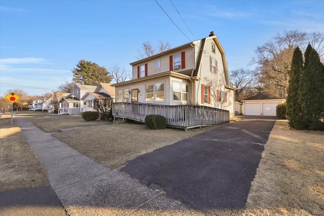 view of front of property featuring a garage and an outbuilding