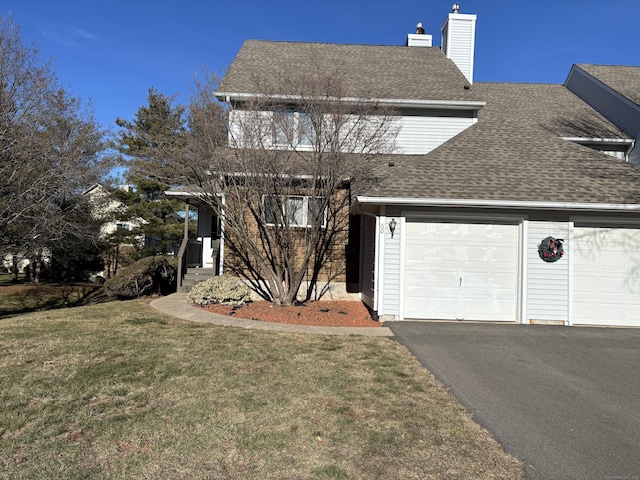 view of front facade with a garage and a front lawn