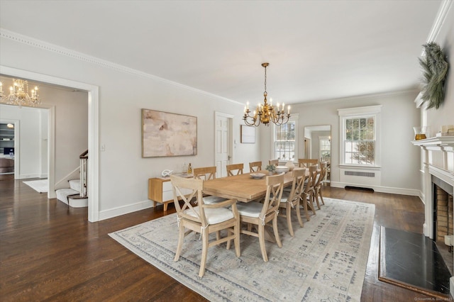 dining area with dark hardwood / wood-style floors, ornamental molding, and a notable chandelier