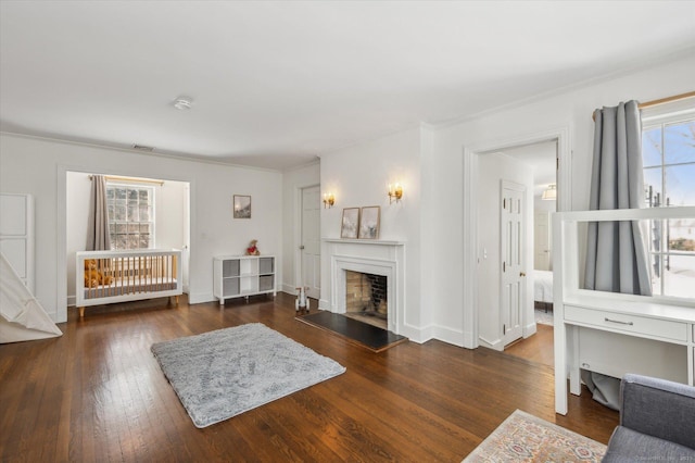 living room with crown molding and dark wood-type flooring