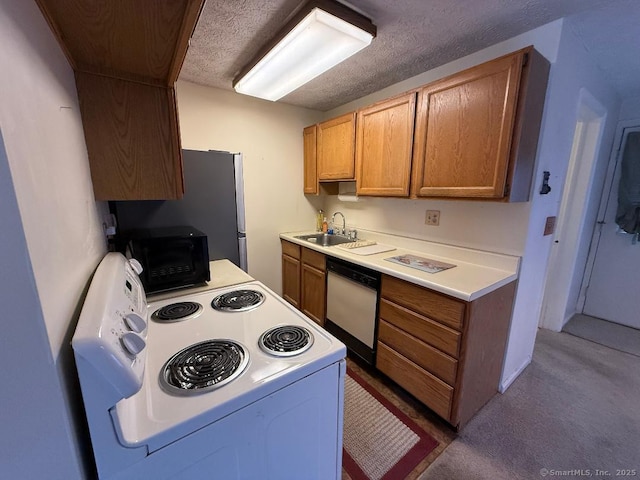 kitchen with a textured ceiling, sink, and white appliances