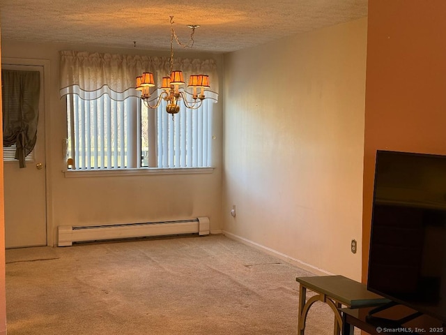 unfurnished dining area featuring carpet floors, baseboard heating, a textured ceiling, and an inviting chandelier