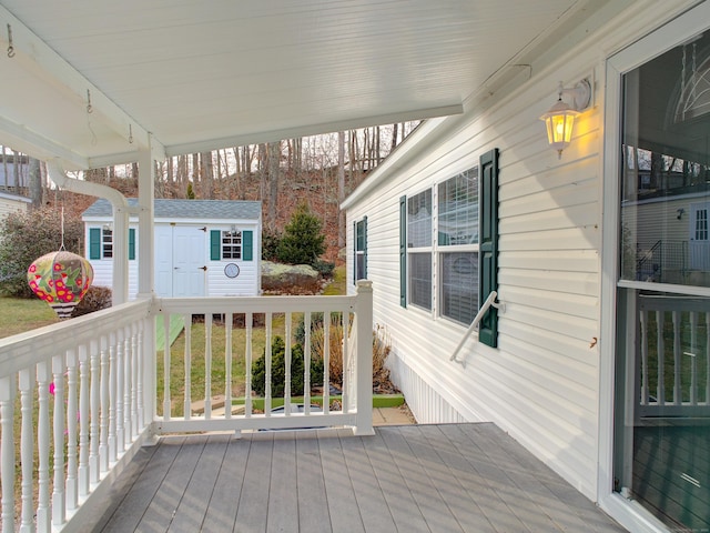 wooden deck featuring a storage unit