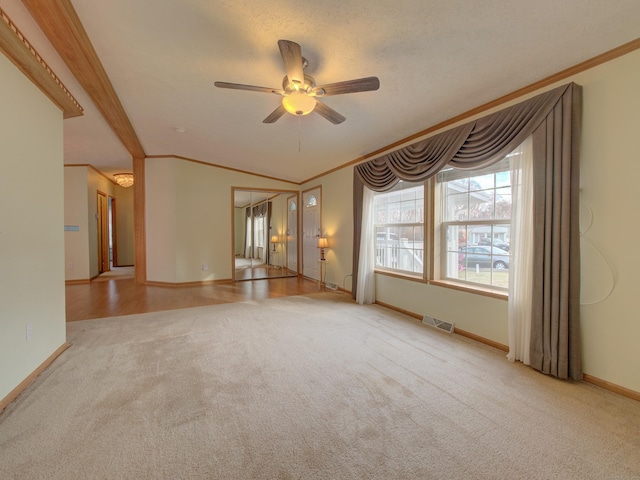 unfurnished living room with ceiling fan, light carpet, and crown molding