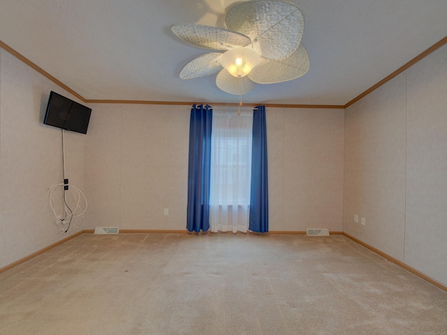 spare room with ceiling fan, carpet, and ornamental molding