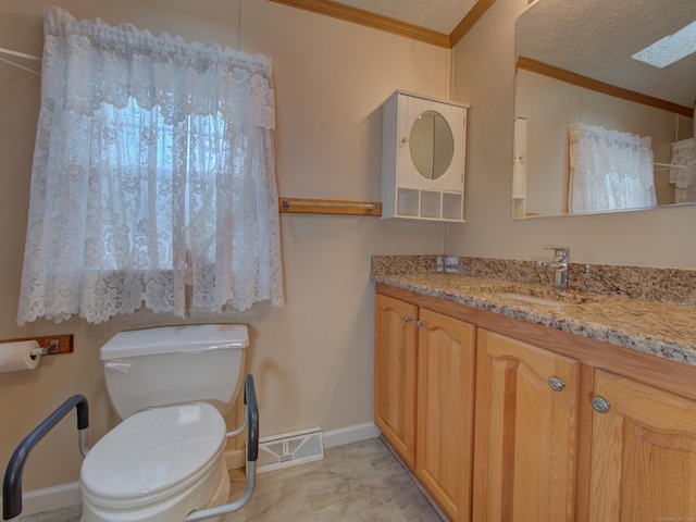 bathroom with a textured ceiling, toilet, vanity, and ornamental molding