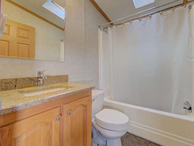 full bathroom featuring a textured ceiling, vanity, toilet, lofted ceiling with skylight, and crown molding