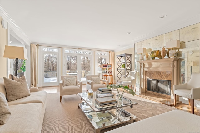 living room with crown molding, french doors, and a fireplace