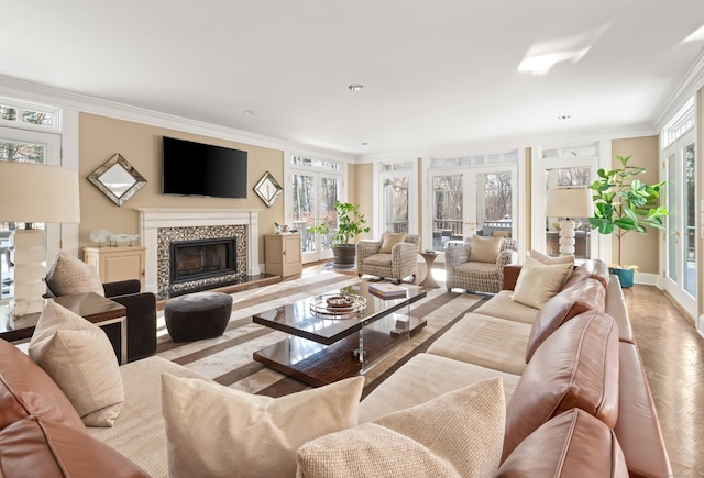 living room with ornamental molding, a tile fireplace, and french doors