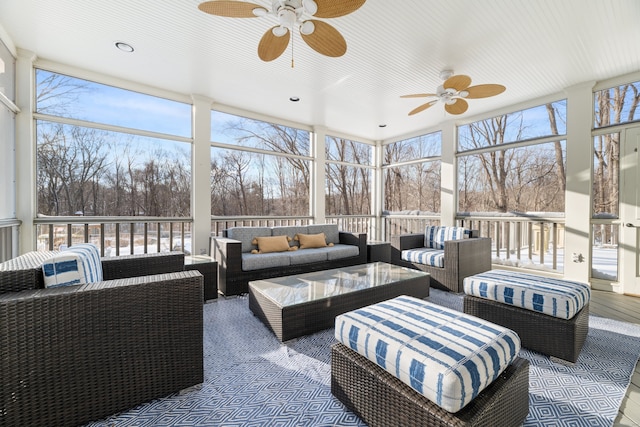 sunroom featuring ceiling fan