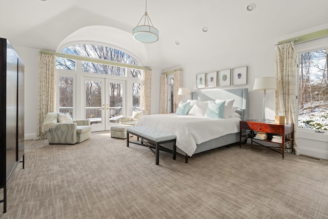 bedroom featuring french doors, high vaulted ceiling, carpet floors, and multiple windows