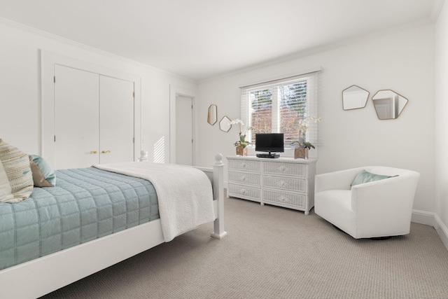 bedroom featuring crown molding, light colored carpet, and a closet