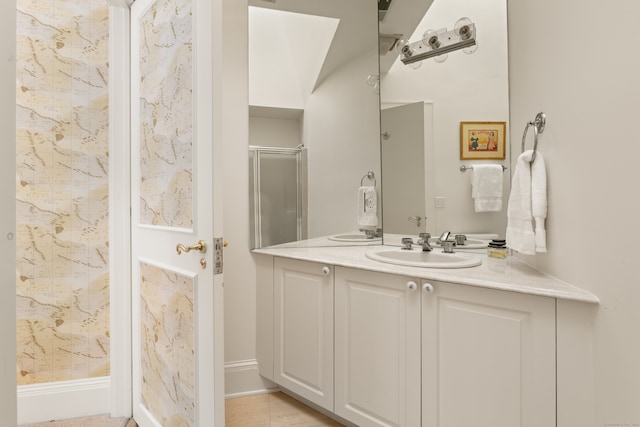 bathroom featuring walk in shower and vanity