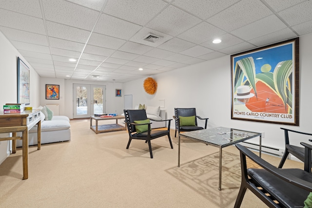 office area with a drop ceiling, carpet, and french doors