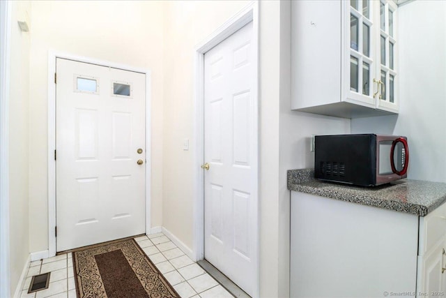 doorway to outside featuring light tile patterned floors