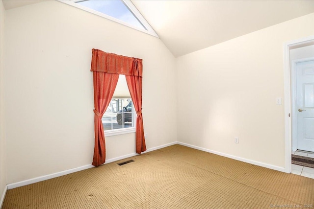 unfurnished room with carpet and vaulted ceiling