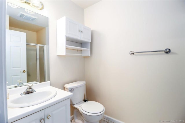 bathroom featuring vanity, toilet, and walk in shower