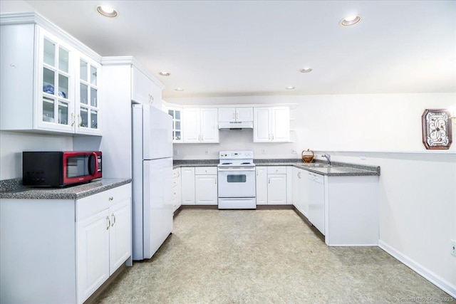 kitchen featuring white cabinets, white appliances, sink, and dark stone counters