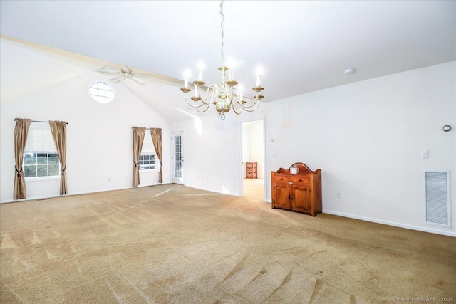 carpeted spare room with ceiling fan with notable chandelier and vaulted ceiling