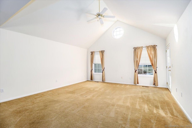 interior space with ceiling fan, light colored carpet, and vaulted ceiling