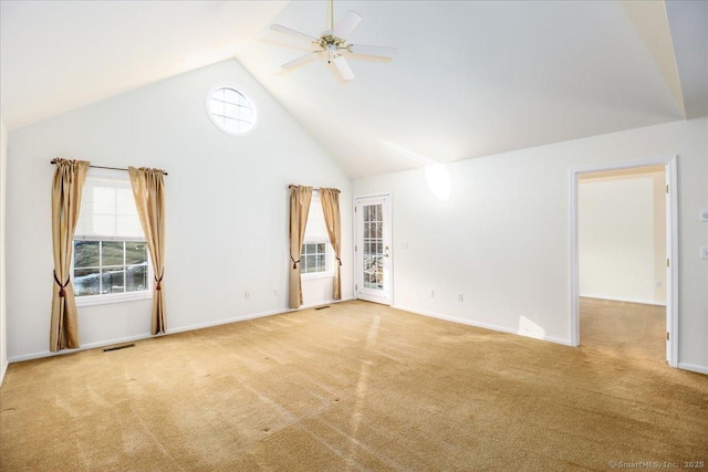 interior space featuring light carpet, ceiling fan, and high vaulted ceiling