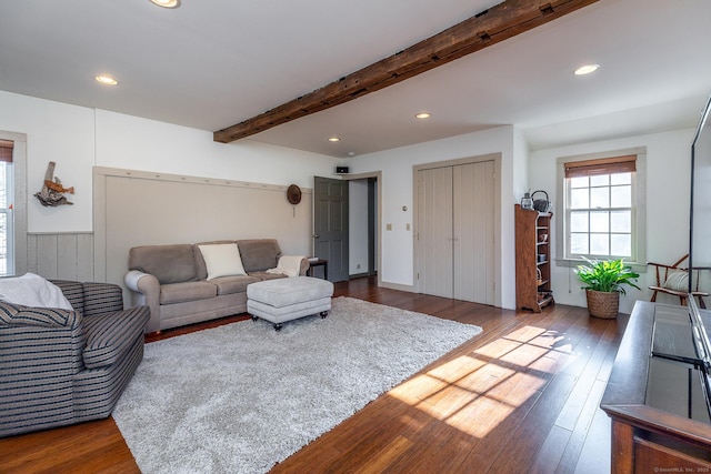 living room featuring beam ceiling and dark hardwood / wood-style floors