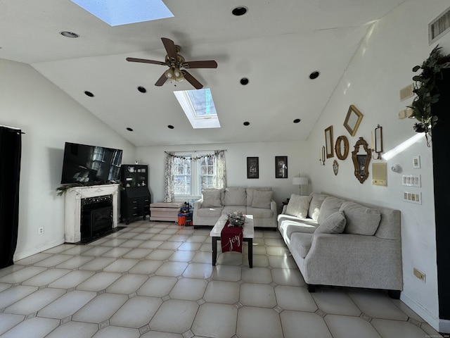 living room featuring ceiling fan, a skylight, and high vaulted ceiling