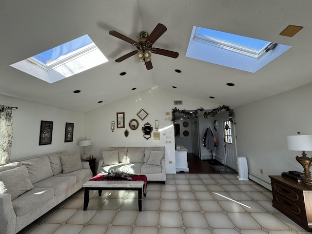 living room with ceiling fan, vaulted ceiling with skylight, and a baseboard heating unit