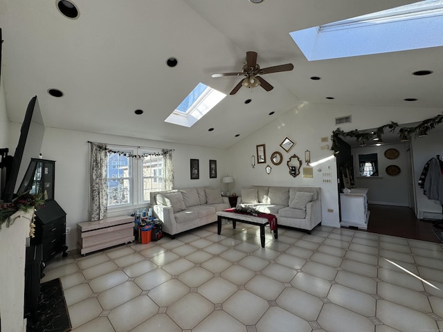 living room featuring a skylight, high vaulted ceiling, and ceiling fan