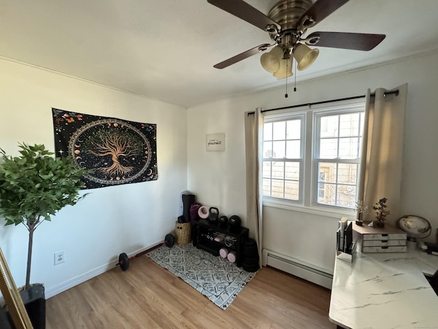 sitting room featuring hardwood / wood-style flooring, ceiling fan, and baseboard heating