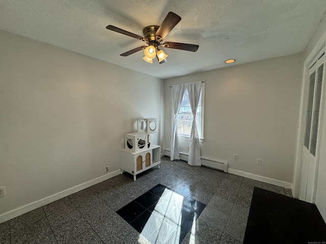 interior space featuring ceiling fan and a textured ceiling