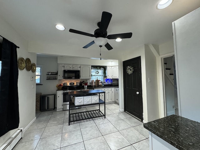 kitchen with ceiling fan, light tile patterned floors, baseboard heating, and electric stove