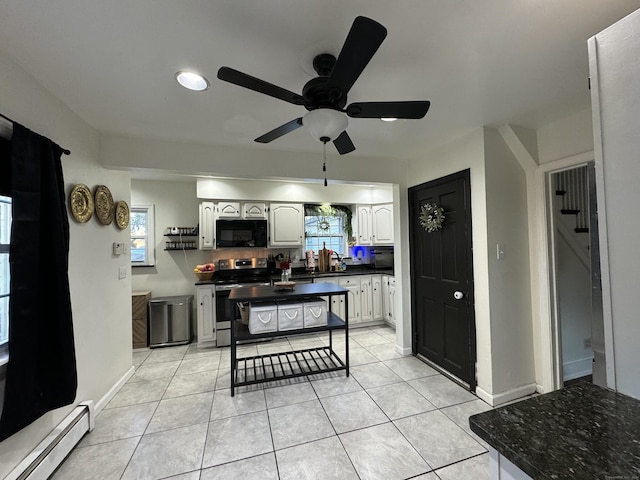 kitchen with stainless steel range with electric stovetop, a baseboard heating unit, white cabinetry, and light tile patterned flooring