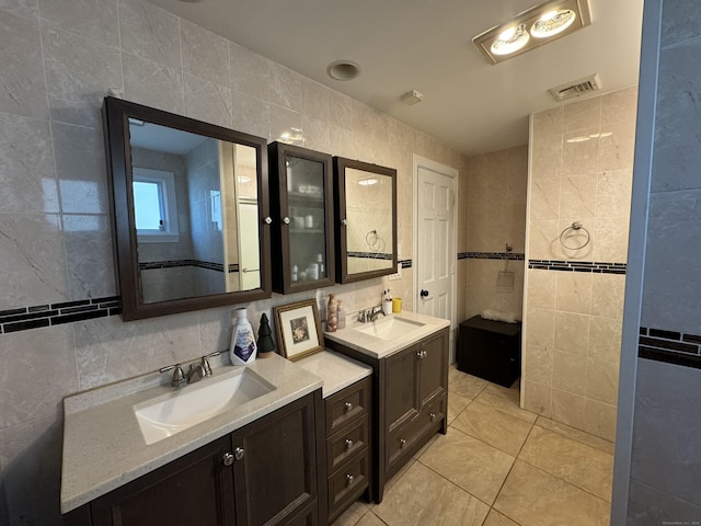 bathroom with tile patterned floors, tile walls, and vanity