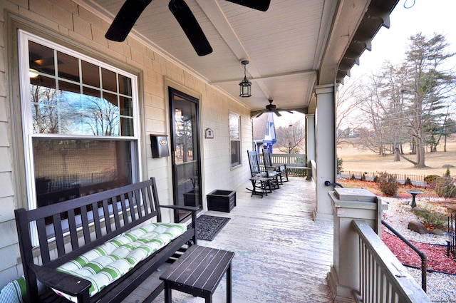 wooden deck featuring covered porch and ceiling fan