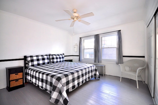 bedroom with crown molding, ceiling fan, radiator heating unit, and dark hardwood / wood-style floors