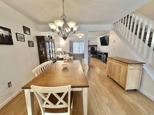 dining room with a notable chandelier and light hardwood / wood-style floors